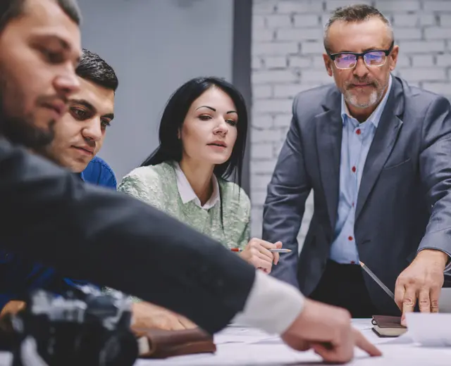 An experienced operator working through a plan with a small team
