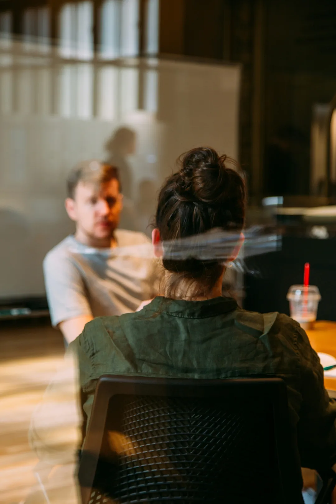 A business owner sitting in a chair in front of a man, calm and in flow