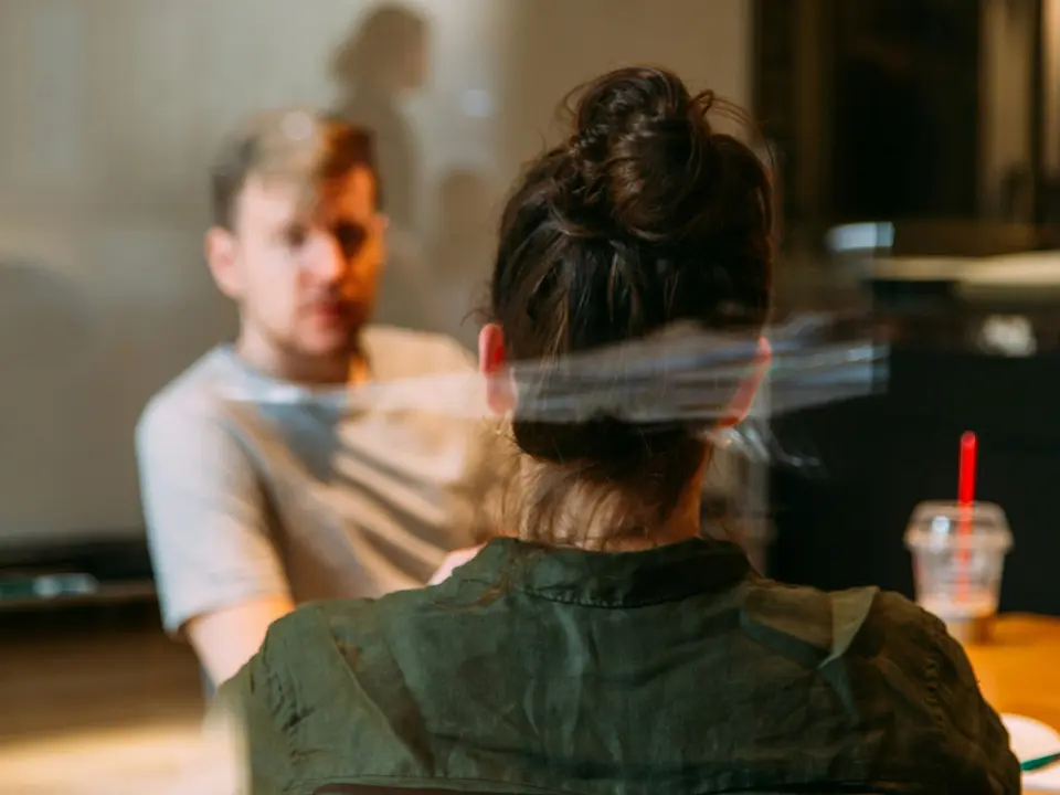 A founder across the table from a job candidate, mid-interview